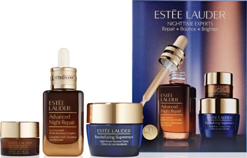 Collection of Estee Lauder night repair skincare products including serum, cream, and eye treatment with a blue and gold display box.