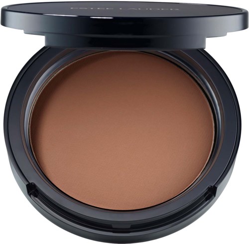 A round black compact with tan-colored pressed powder inside, slightly open lid showing the product.