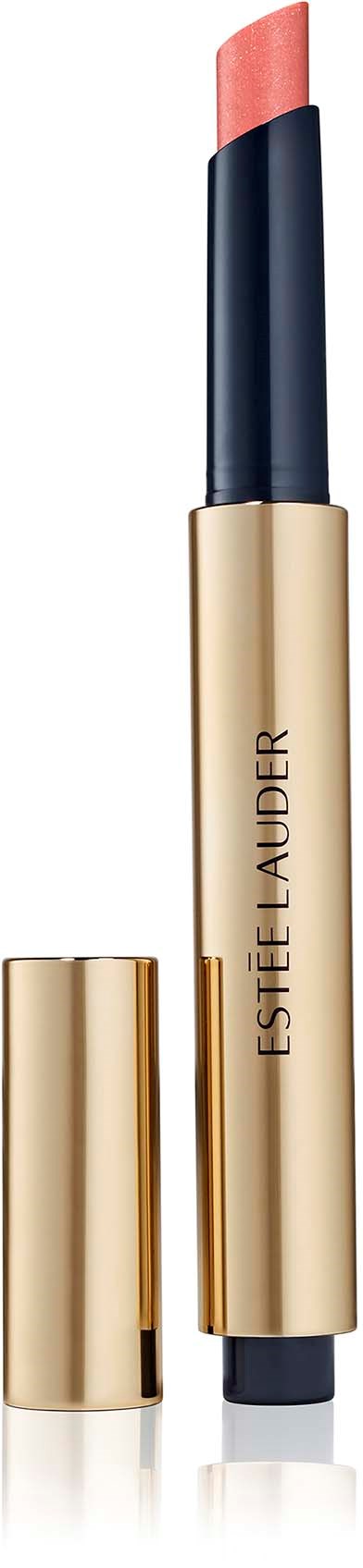 A peach-colored lipstick in a gold tube with a black cap, branded Estée Lauder, standing upright.