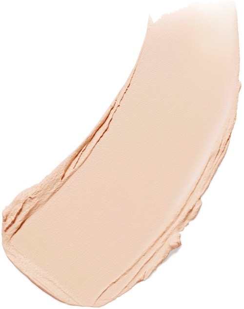Creamy beige foundation swatch on skin with smooth texture and brush strokes visible.