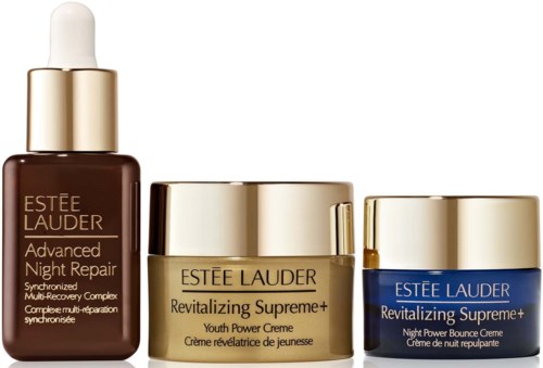 Three Estee Lauder skincare products with gold caps and blue and gold lids, labeled Advanced Night Repair and Revitalizing Supreme+.