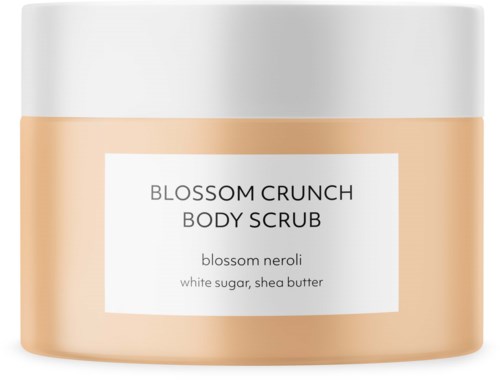 Een potje Blossom Crunch Body Scrub met bloesem neroli, witte suiker en sheaboter. De pot heeft een witte deksel.