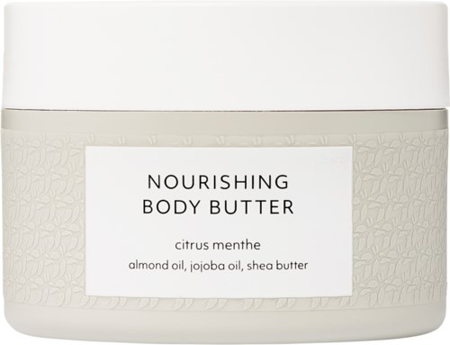 Een witte pot met voedende lichaamsboter met citrus menthe geur, bevat amandelolie, jojoba-olie en sheabutter.