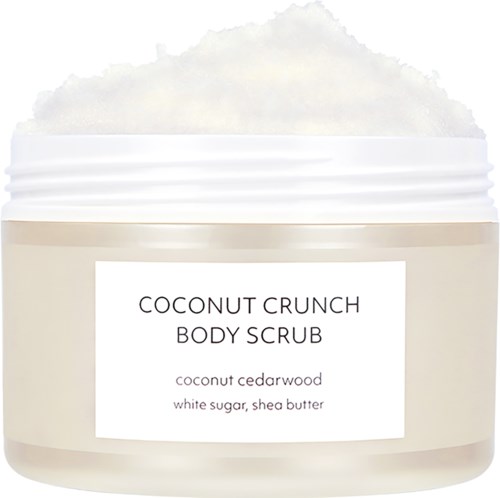 A creamy body scrub labeled "Coconut Crunch" with coconut cedarwood scent, contains white sugar and shea butter.