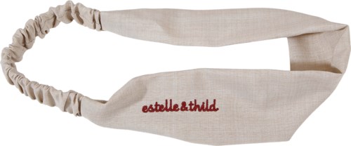 Een beige hoofdband met rode tekst 'estelle&thild'. Het is gemaakt van zacht stof en heeft een elastische kant.