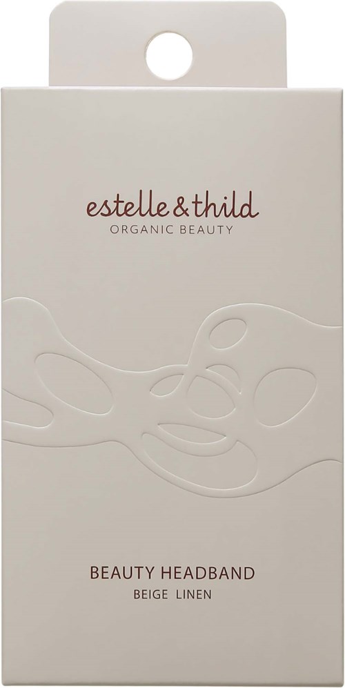 Eenvoudige witte doos met handvat. Text leest 'estelle & thild.' en noemt 'Beauty Headband Beige Linen.'