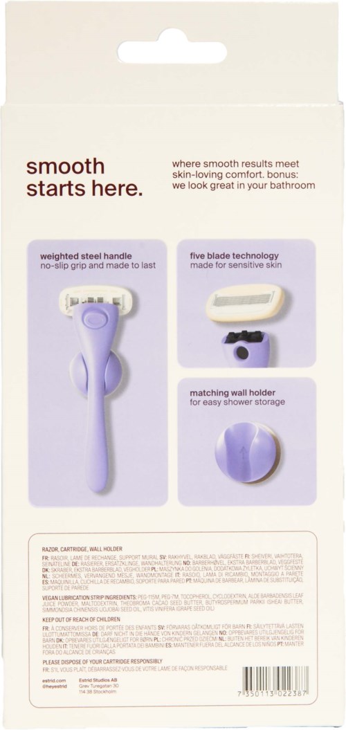 Packaging shows a razor with a weighted steel handle, five-blade technology, and matching wall holder in soft purple.