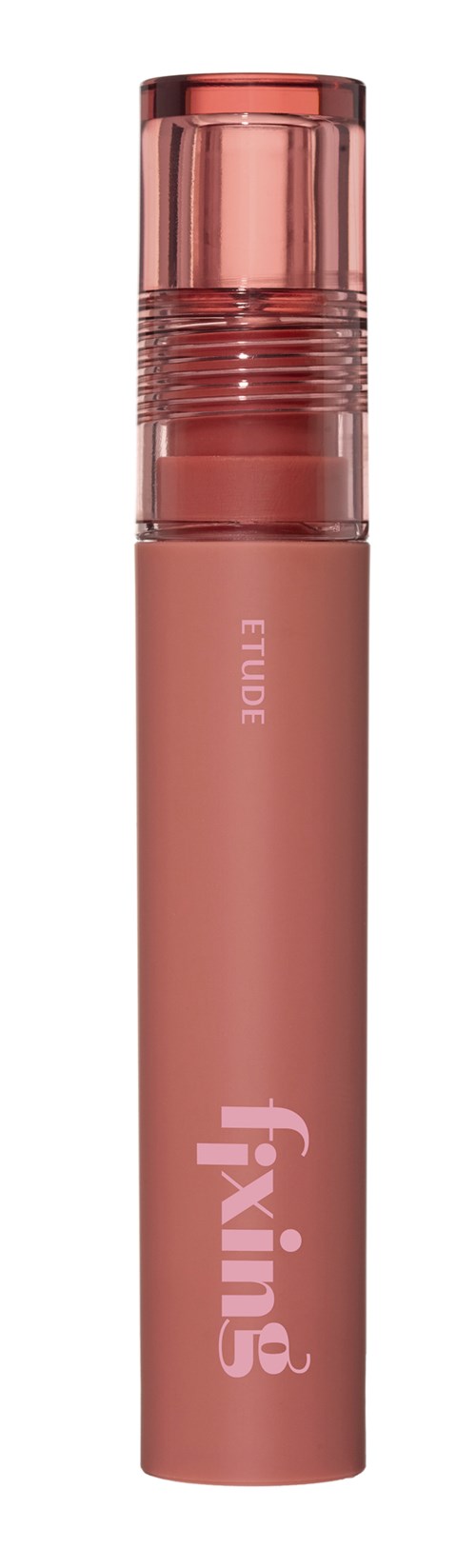 A pink, cylindrical cosmetic product with a transparent cap and the words Fixing and Eude written on it.
