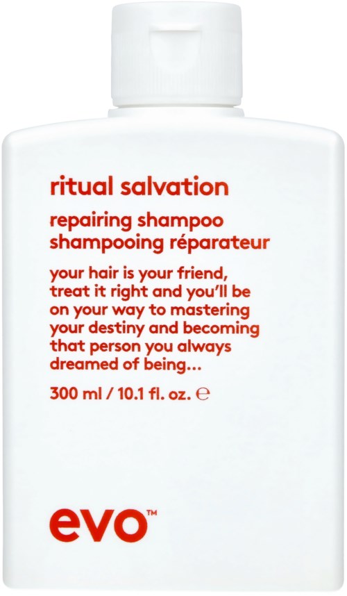 A white bottle labeled 'ritual salvation repairing shampoo' with red and black text, and a small logo at the bottom.