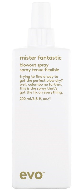 A white spray bottle labeled 'mister fantastic blowout spray' with gold and black text, and a spray nozzle at the top.