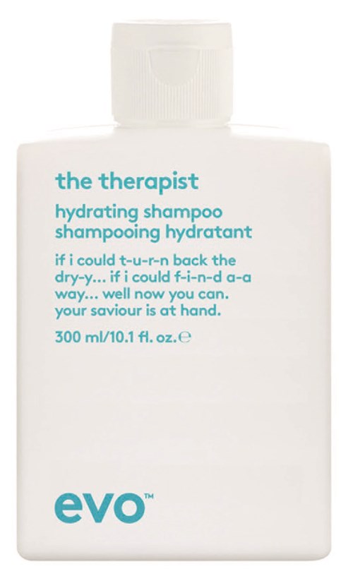 Eine weiße Shampooflasche mit türkisem Text, namens 'the therapist' und 'evO'. Es erwähnt Feuchtigkeit und Rettung für trockenes Haar.
