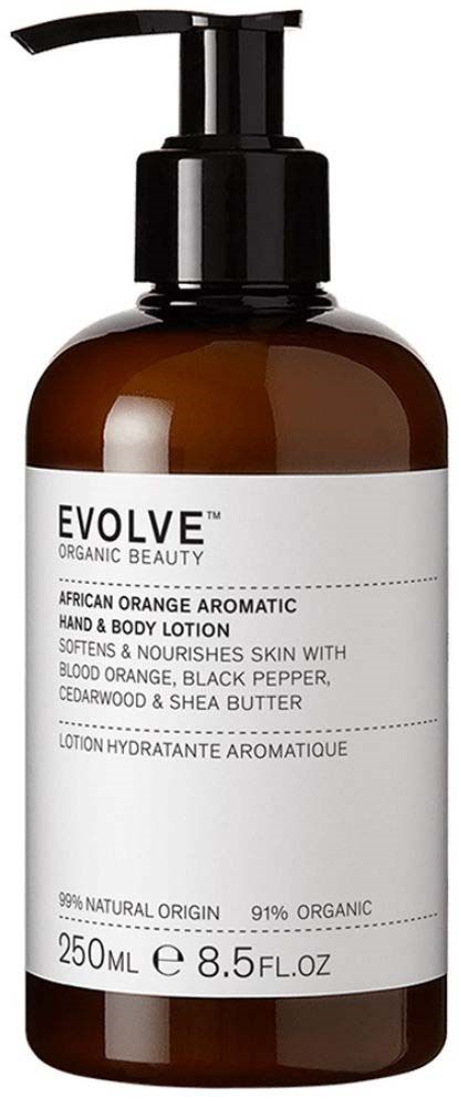 Eine braune Flasche mit schwarzem Pumphals, beschriftet mit 'Evolve Organic Beauty African Orange Aromatic Hand & Body Lotion,' 250 ml.