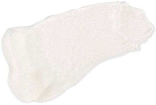 Eine unregelmäßig geformte weiße Spur von Creme oder Lotion auf einfachem Hintergrund.