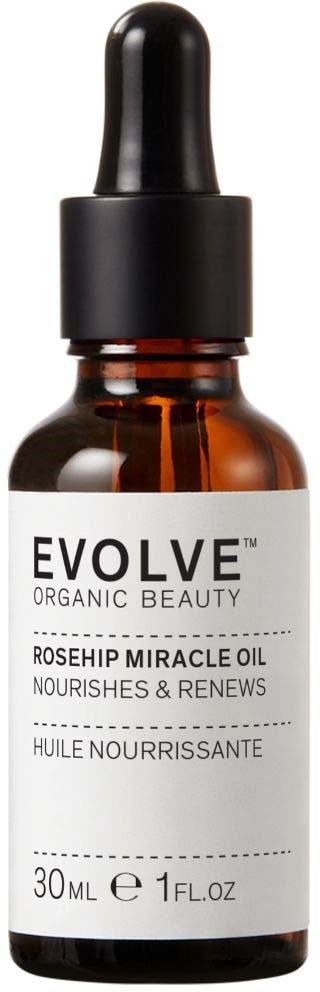 Eine kleine braune Flasche mit Pipette, beschriftet Evolve Organic Beauty, Rosehip Miracle Oil für die Hautpflege.