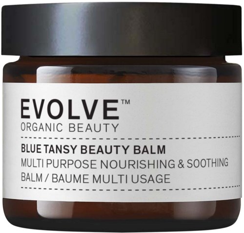 Evolve-merkkinen sininen tansy -kauneusbalm, jossa valkoinen etiketti ja musta kansi, kuvaillaan ravitsevaksi ja rauhoittavaksi.