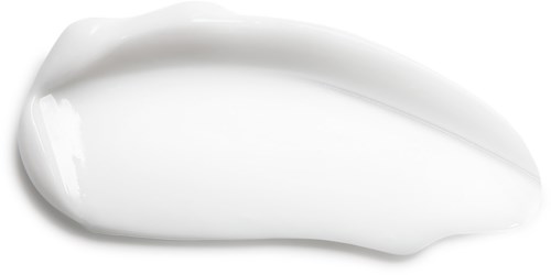 White cream spread in a small, curved shape on a black background.