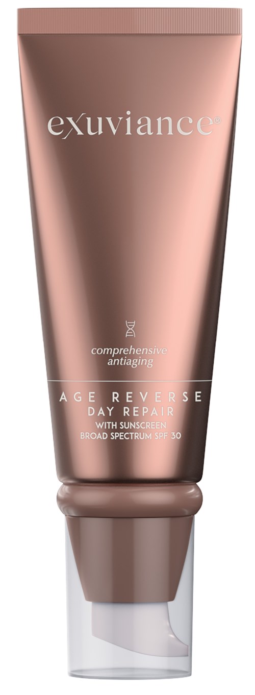 Eine pinke Tube mit Hautcreme kennzeichnet 'exuviance' für Anti-Aging und Sonnenschutz, mit klarem Deckel.