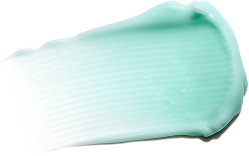 Mintgrüne Creme auf schwarzem Hintergrund mit sichtbarer Textur und glatter Oberfläche.