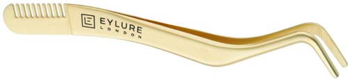 A beige eyelash curlers with a curved shape and ribbed grip area, marked with 'EYLURE LONDON'.
