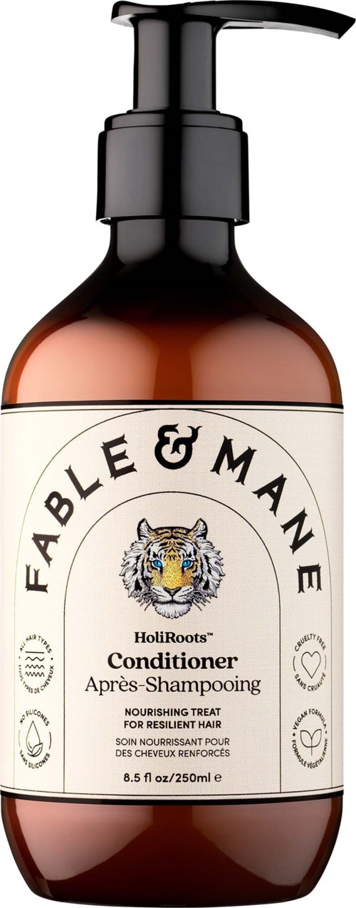 Brun flaska med svart pump märkt Fable & Mane HoliRoots balsam för motståndskraftigt hår.