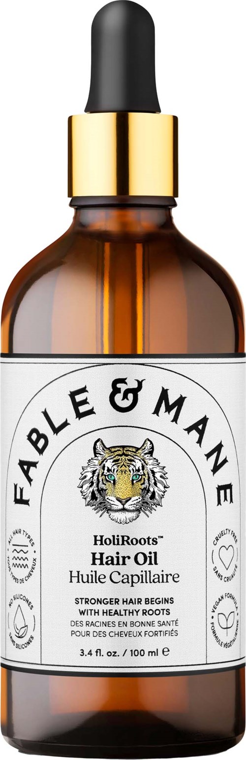 En brun glasflaska med svart dragrörslocke och vit etikett med Fable & Mane-loggan och text.