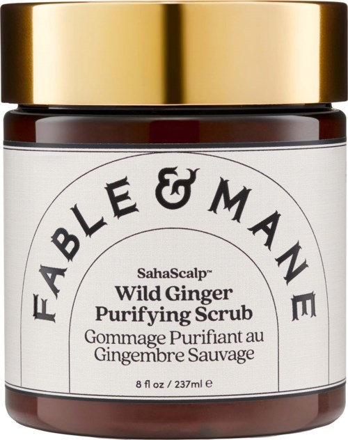 En burk med Fable & Mame Wild Ginger Purifying Scrub med gulddoscha och vit etikett.