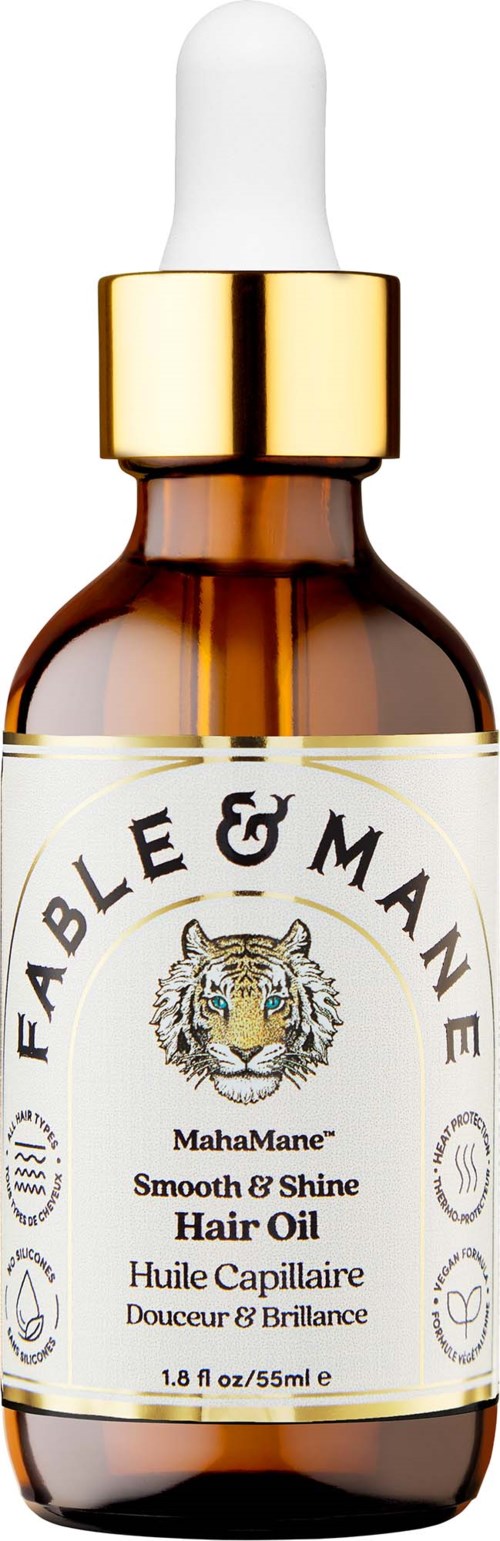 En brun glasflaska med vit pipettlock, märkt Fable & Mane MahaMane hårolja, med tigerlogga och gulddetaljer.