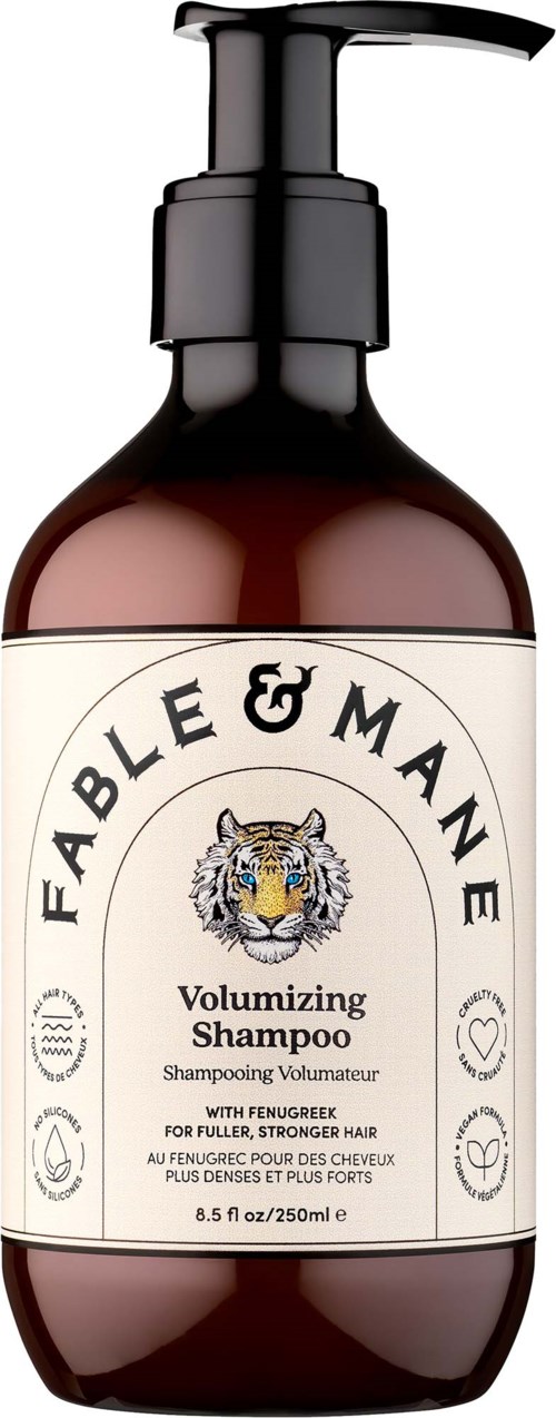 Volumenshampoo-flaska med pump, etiketten visar ett tigeransikte och text om fylligt, starkt hår.