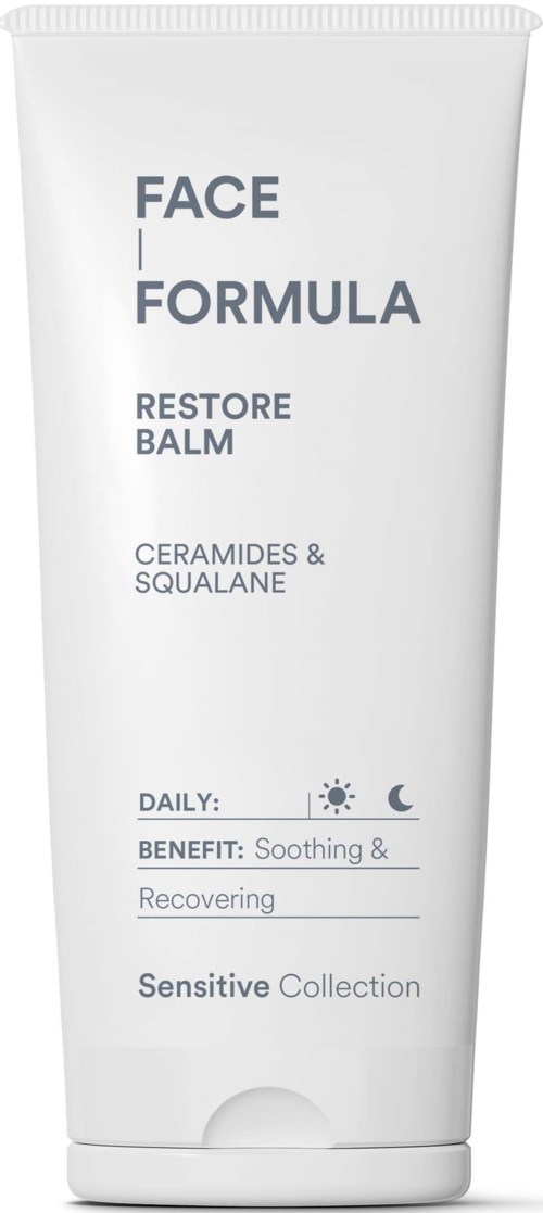 A white tube of face cream labeled Face Formula Restoring Balm with ceramides and squalane, good for sensitive skin.
