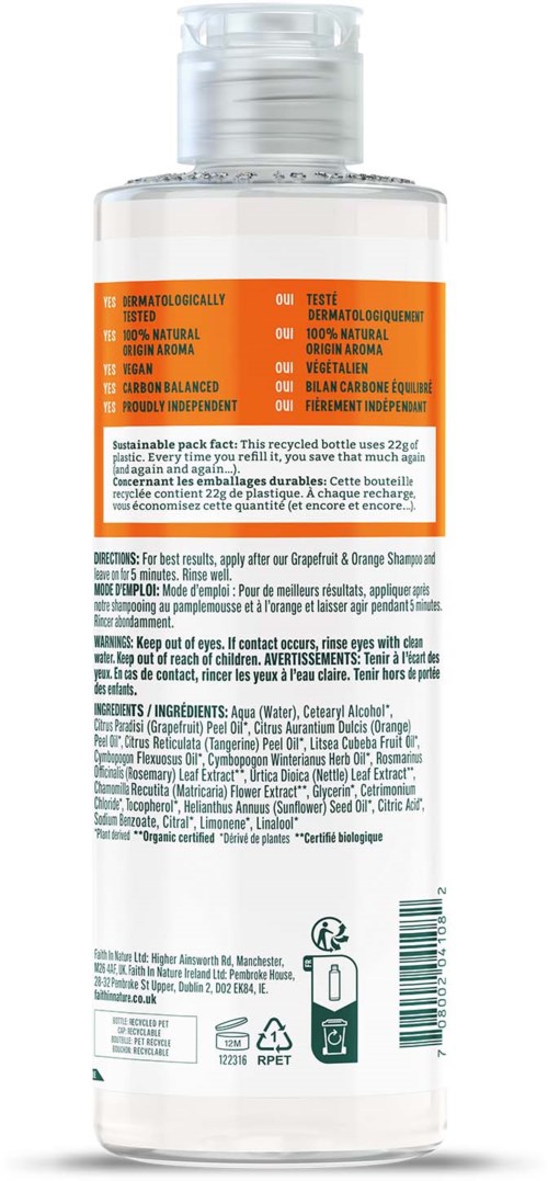 A clear bottle with orange label and black text, containing shampoo for hair care, with a flip cap on top.