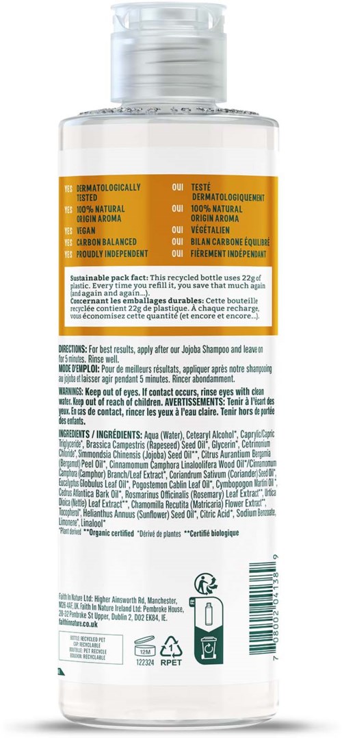 A clear plastic bottle with a white cap, orange label, and small text, likely a cosmetic or personal care product.