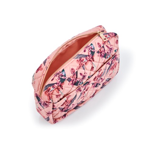 A pink quilted bag with a floral print and a zipper, designed for carrying personal items.