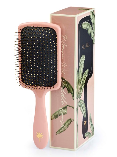 A pink hairbrush with black bristles and a palm tree logo on the handle. Comes with decorative box featuring leaves.