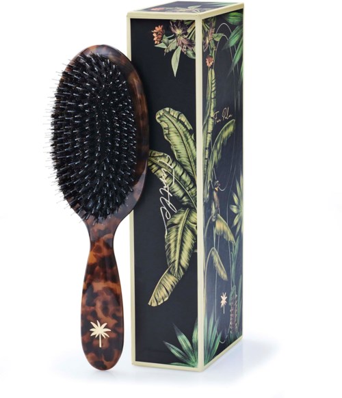 A hairbrush with a leopard print handle and a floral design box.