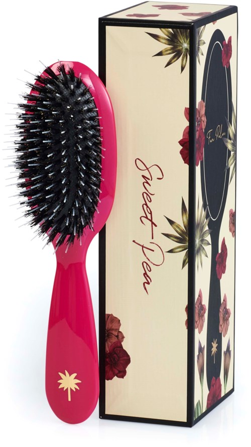 A pink hairbrush with black bristles and a decorative box with floral patterns and the words 'Sweet Plea' are shown.