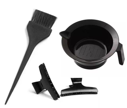 A small brush, a black ashtray, and two black clips, probably for hair or clothing.