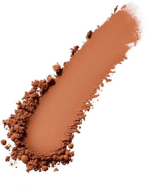 A streak of brown powder spread out on a white background, with some powder clumps around the edges.