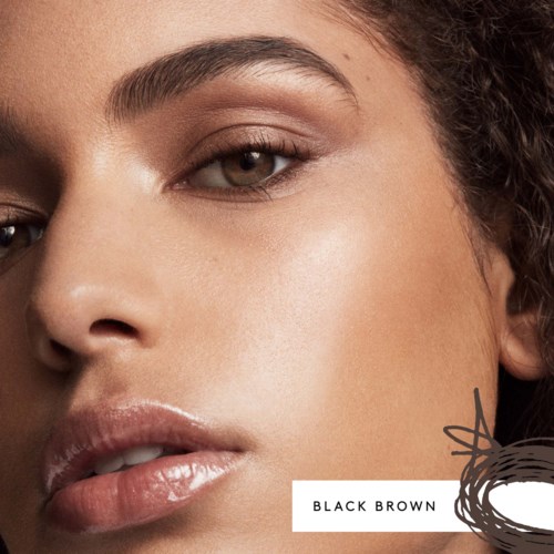 Close-up of a woman's face with smooth skin, brown eyes, and full lips, showing a natural look.