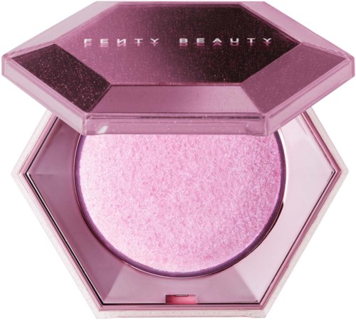 A pink, glittery makeup product in a hexagon-shaped case with a lid that says Fenty Beauty.