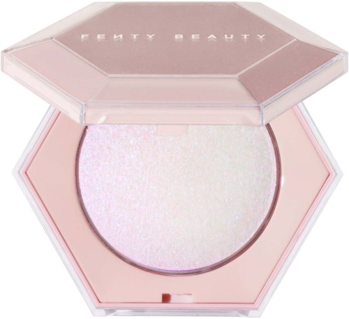 A Fenty Beauty compact with a pink, hexagon-shaped lid and shiny, iridescent powder inside.