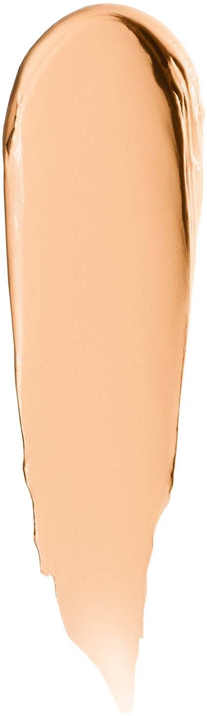 A vertical swatch of beige liquid makeup with darker edges, pouring downward.