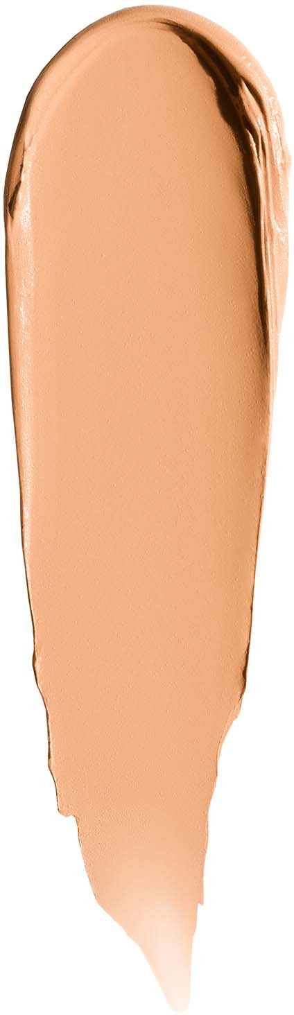A streak of beige makeup on a white background with a hint of darker edges.