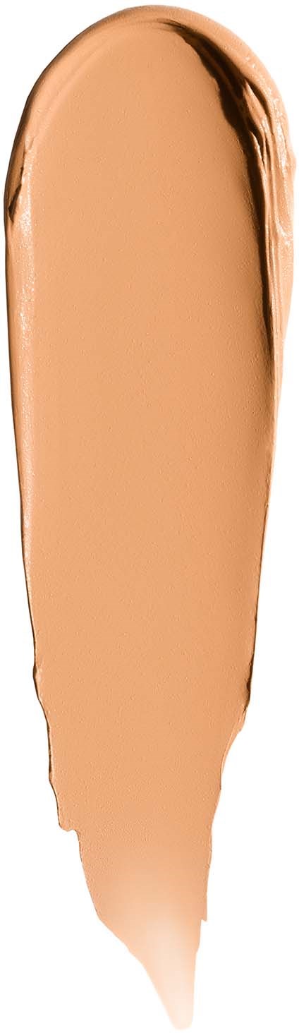 A beige liquid with a darker edge, spread in a elongated shape on a white background.