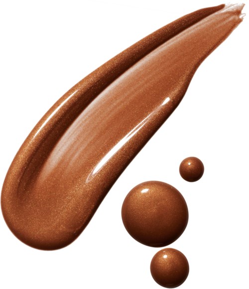 Three brown makeup spheres and a swatch of shiny brown makeup cream or lotion.