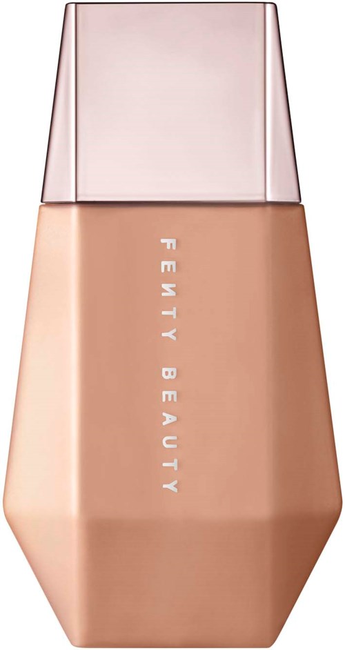 A beige foundation bottle with a pink cap, labeled "Fenty Beauty". Sleek and modern design.