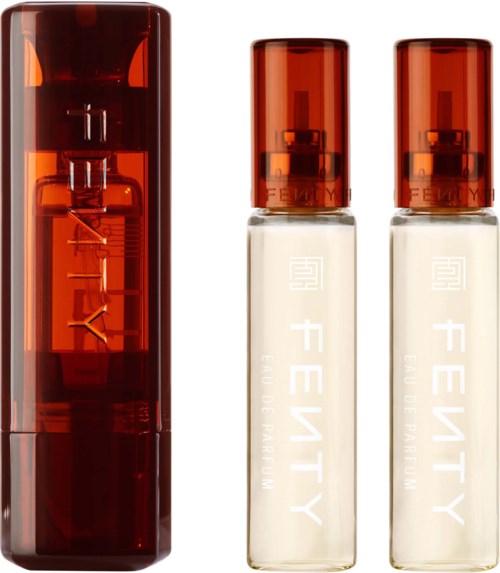 Three perfume bottles, one large dark amber and two smaller clear bottles with amber caps.