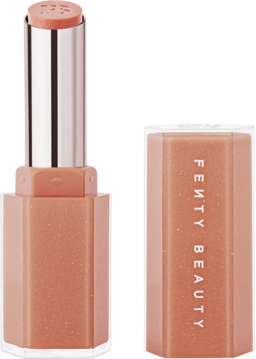 Lipstick with a peach-colored tube and a shiny silver cap, labeled 'Fenty Beauty.'