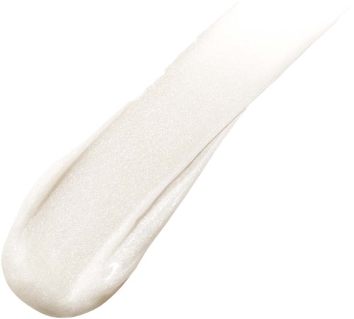 White cream or lotion is spread on a surface, likely skincare or cosmetic product.