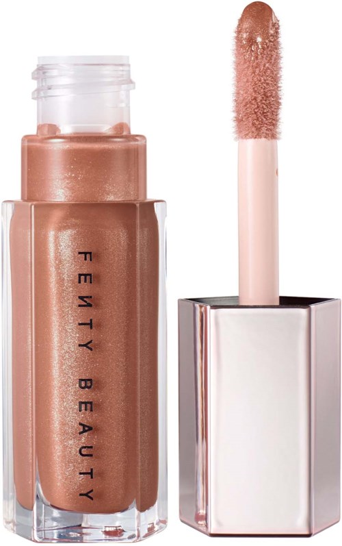 A lip gloss tube and applicator with rose gold and pink tones, labeled Fenty Beauty.