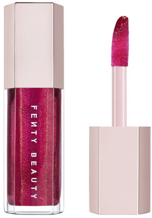 A lip gloss tube with pink glittery gloss and an applicator wand.